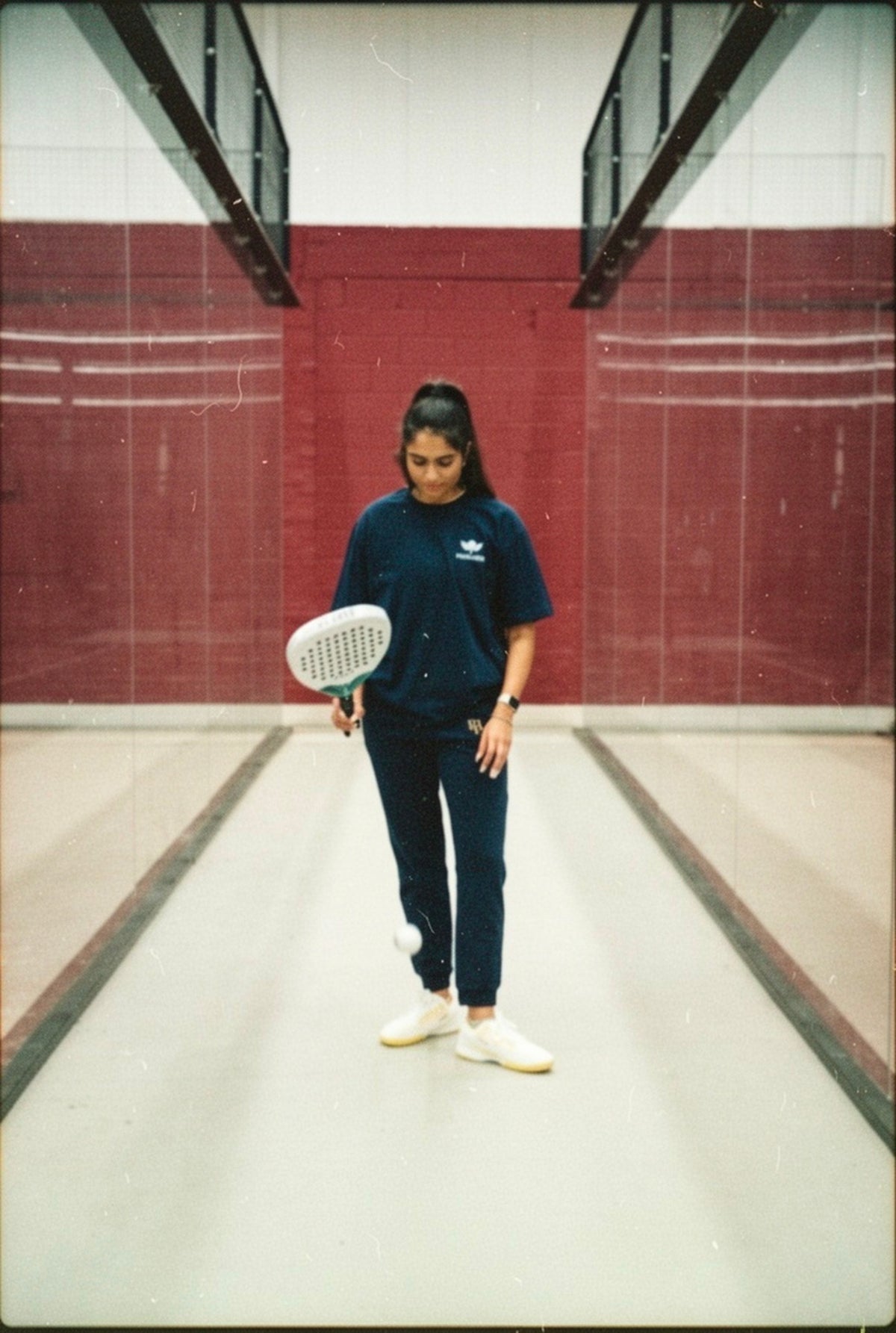 Woman on a padel court in the Padel Pilates Yoga Weights Tee, a padel gift for her | The Hud